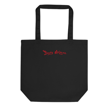 A black eco tote bag with a playful logo spelling out the name 'Donny Meloche'. © Donny Meloche, 2023.