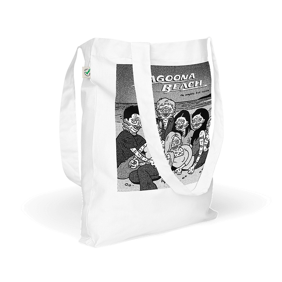 Side view of a white tote bag featuring a graphic illustration of 'Lagoona Beach' with creatures from the Black Lagoon sprawled on a sandy beach. © Donny Meloche, 2023.