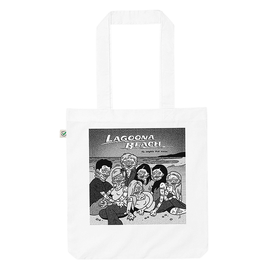 A white tote bag featuring a graphic illustration of 'Lagoona Beach' with creatures from the Black Lagoon sprawled on a sandy beach. © Donny Meloche, 2023.