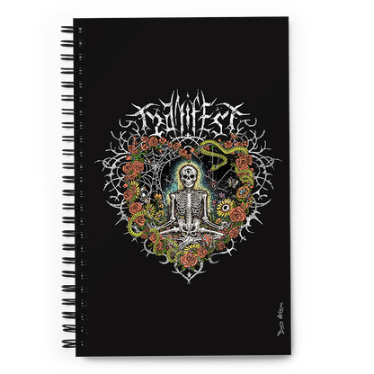 The front of a spiral notebook journal with vibrant digital artwork of a meditating skeleton in a yoga pose amid colorful flowers and insects. A bluebird sits on the skeleton's shoulder. It's framed by a heart-shaped iron fence with snakes, roses, and gothic 'Manifest' text. Expressive eyes and a third eye symbolize spiritual awakening. Despite the edgy look, it carries an uplifting message of manifestation and abundance. © Donny Meloche, 2023.