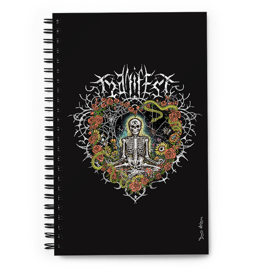 The front of a spiral notebook journal with vibrant digital artwork of a meditating skeleton in a yoga pose amid colorful flowers and insects. A bluebird sits on the skeleton's shoulder. It's framed by a heart-shaped iron fence with snakes, roses, and gothic 'Manifest' text. Expressive eyes and a third eye symbolize spiritual awakening. Despite the edgy look, it carries an uplifting message of manifestation and abundance. © Donny Meloche, 2023.