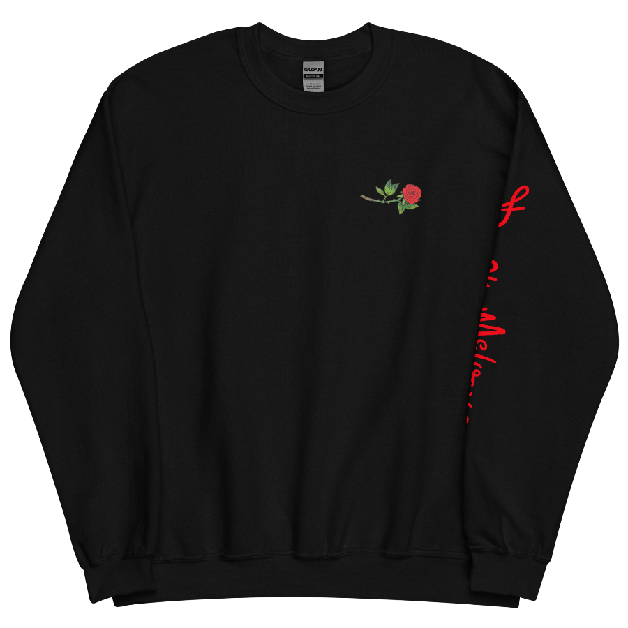The front of a black sweatshirt with a small illustration of a tilted red rose; placed over the heart on the left side of the chest. © Donny Meloche, 2023.