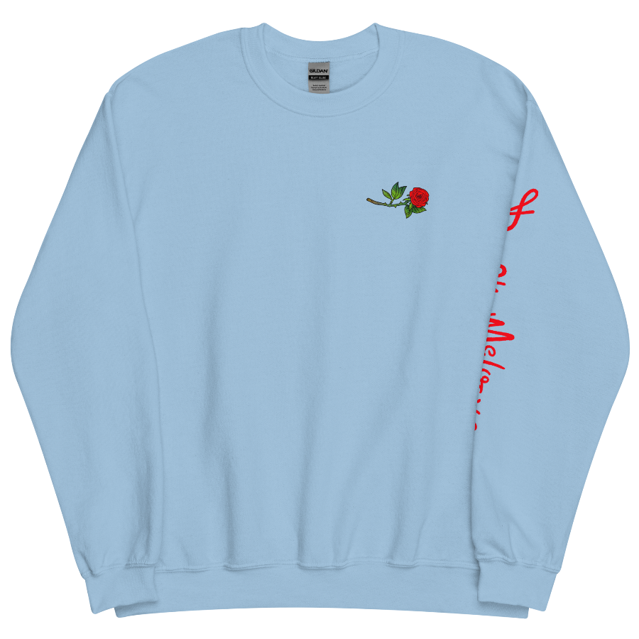 The front of a blue sweatshirt with a small illustration of a tilted red rose; placed over the heart on the left side of the chest. © Donny Meloche, 2023.