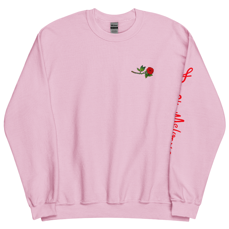 The front of a pink sweatshirt with a small illustration of a tilted red rose; placed over the heart on the left side of the chest. © Donny Meloche, 2023.