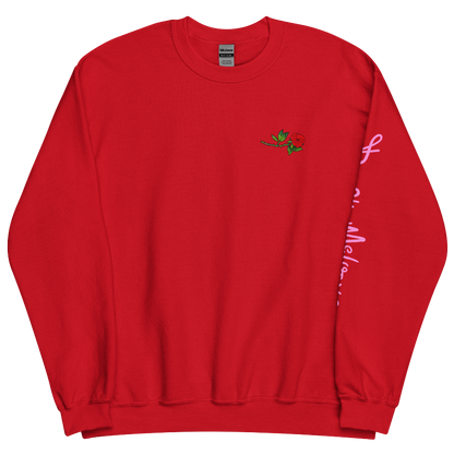The front of a red sweatshirt with a small illustration of a tilted red rose; placed over the heart on the left side of the chest. © Donny Meloche, 2023.